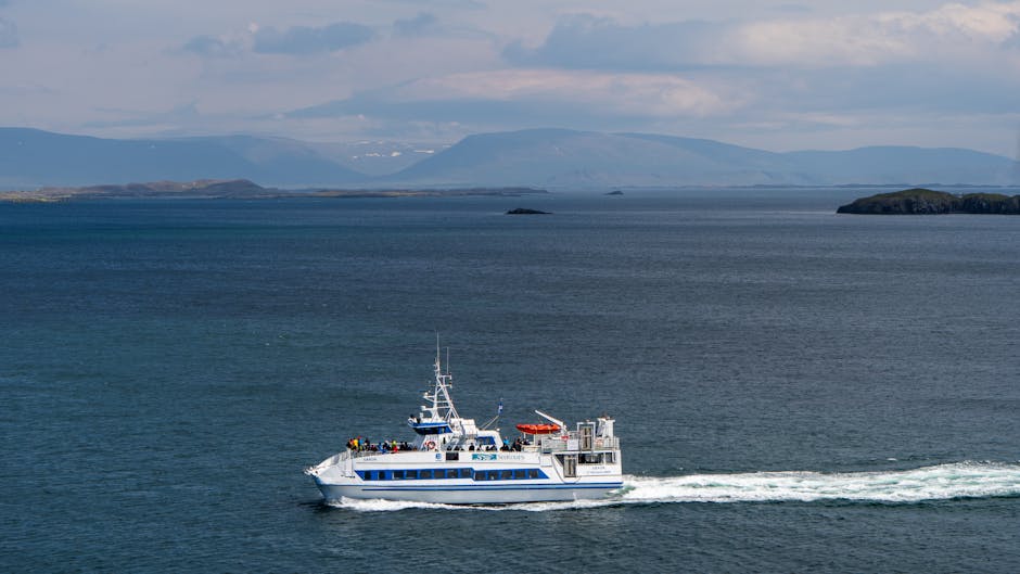 Passenger ferry sailing through calm waters with distant mountains in Iceland. — Photo de Zak Mir sur Pexels